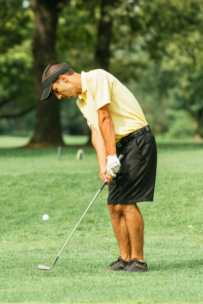 golfer taking a chip shot